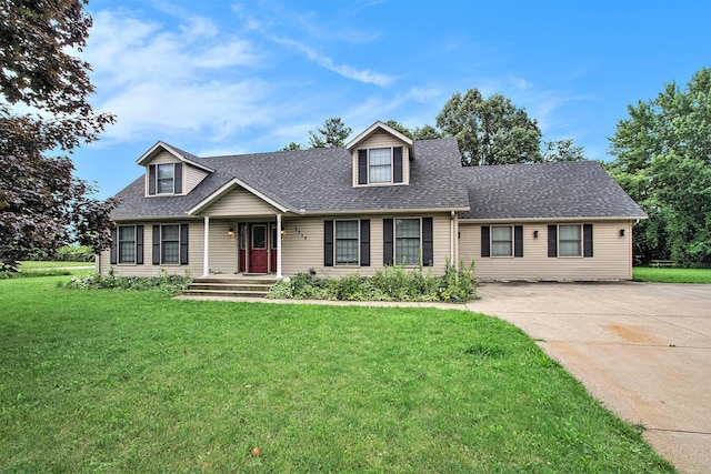 3316 W Lemon Creek Rd, Bridgman, MI 49106 - cape cod-style house with a shingled roof, a front yard, and concrete driveway