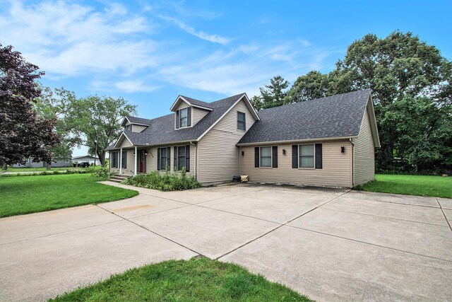 3316 W Lemon Creek Rd, Bridgman, MI 49106 - view of front of house with a shingled roof, concrete driveway, and a front yard