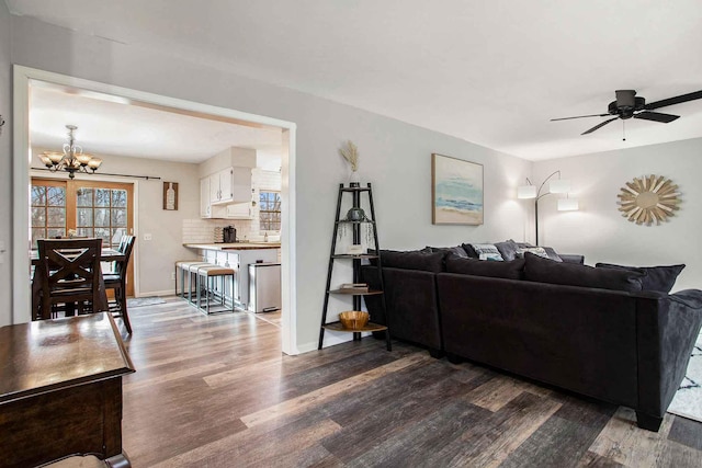 3316 W Lemon Creek Rd, Bridgman, MI 49106 - living area with dark wood finished floors, a chandelier, a ceiling fan, and baseboards