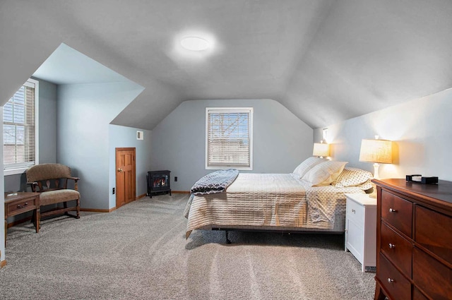 3316 W Lemon Creek Rd, Bridgman, MI 49106 - carpeted bedroom with a wood stove, multiple windows, lofted ceiling, and baseboards