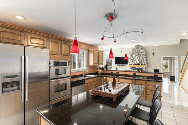 17 Coronado Dr, Jackson, MI 49201 - kitchen with light tile patterned floors, a center island, a sink, appliances with stainless steel finishes, and a peninsula