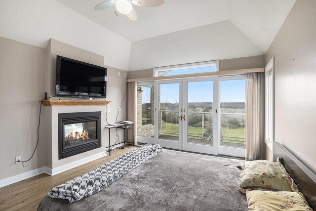 17 Coronado Dr, Jackson, MI 49201 - living area with wood finished floors, ceiling fan, vaulted ceiling, and a multi sided fireplace