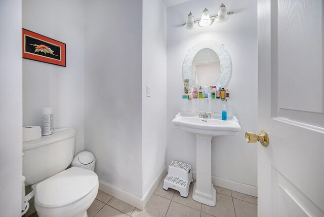 17 Coronado Dr, Jackson, MI 49201 - bathroom featuring tile patterned floors, baseboards, and toilet