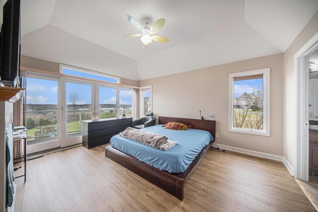 17 Coronado Dr, Jackson, MI 49201 - bedroom with light wood-style floors, a ceiling fan, access to exterior, lofted ceiling, and french doors