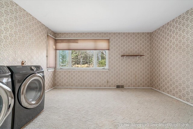 1220 W Green St, Hastings, MI 49058 - clothes washing area with separate washer and dryer, wallpapered walls, carpet flooring, visible vents, and laundry area