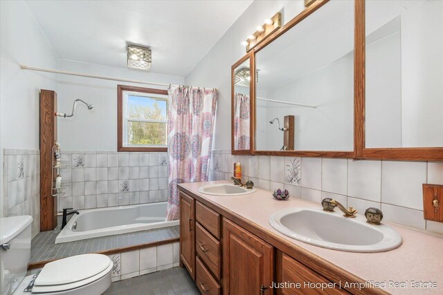1220 W Green St, Hastings, MI 49058 - bathroom with toilet, double vanity, a sink, and tile walls