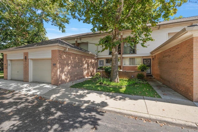 1118 Stafford Pl, Detroit, MI 48207 - exterior space with brick siding, driveway, and an attached garage