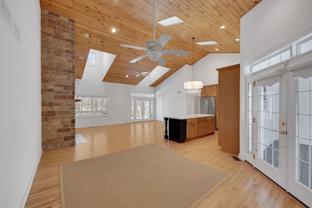 interior space featuring ceiling fan with notable chandelier, high vaulted ceiling, wooden ceiling, french doors, and light wood finished floors