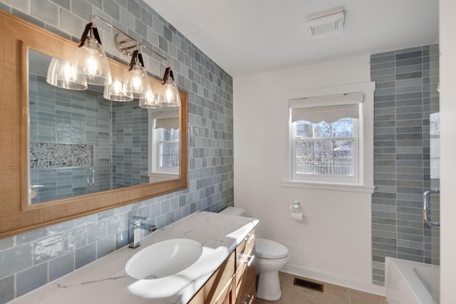 full bath featuring visible vents, toilet, tile walls, and vanity