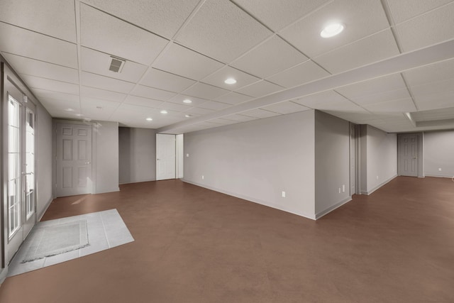 below grade area with visible vents, recessed lighting, and a drop ceiling