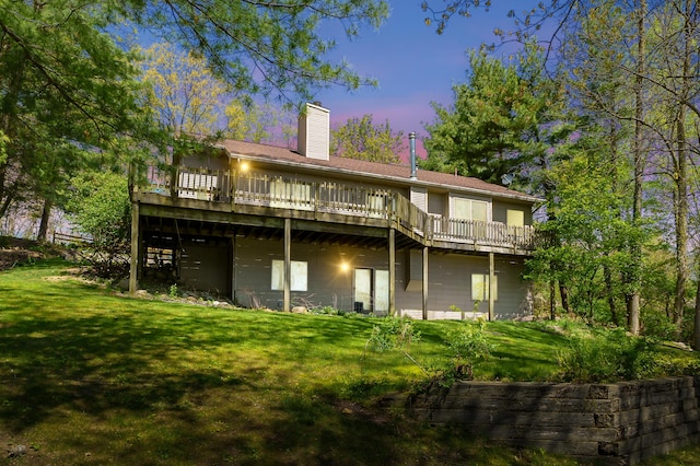 10511 Stoney Point Dr, Delton, MI 49046 - rear view of property with a wooden deck, a chimney, and a lawn