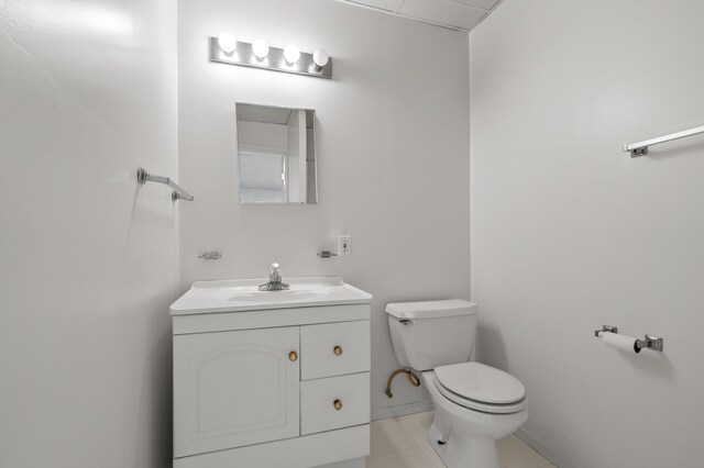 10511 Stoney Point Dr, Delton, MI 49046 - bathroom featuring toilet, vanity, tile patterned flooring, and baseboards