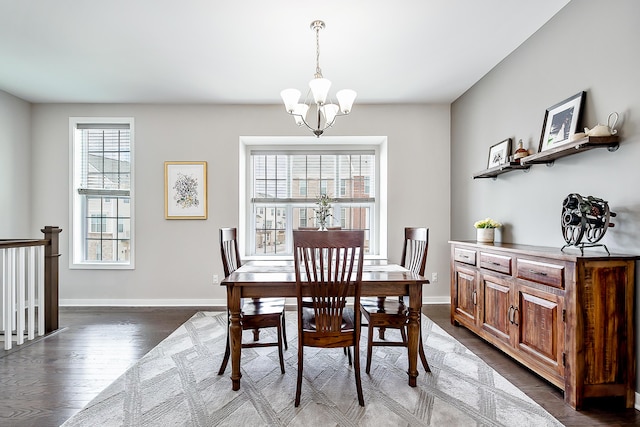 dining area featuring baseboards, dark wood-style floors, and an inviting chandelier