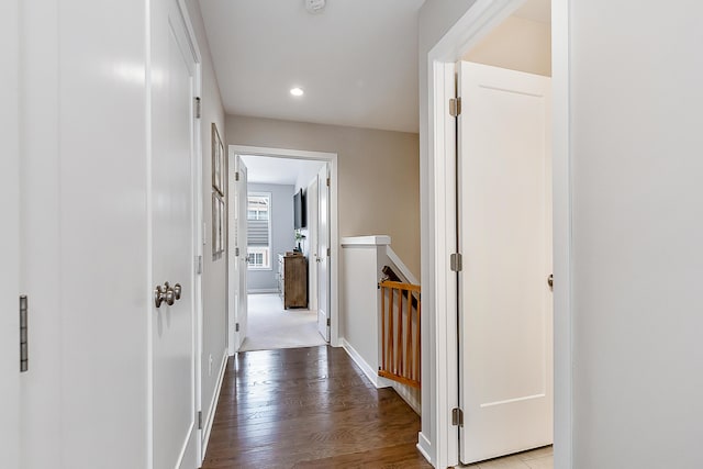 hall featuring baseboards, wood finished floors, an upstairs landing, and recessed lighting