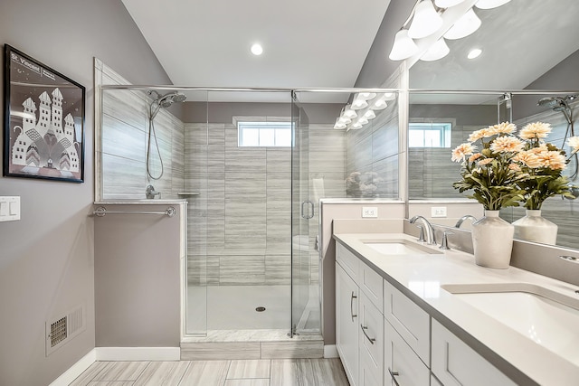 full bathroom with baseboards, a sink, visible vents, and a stall shower