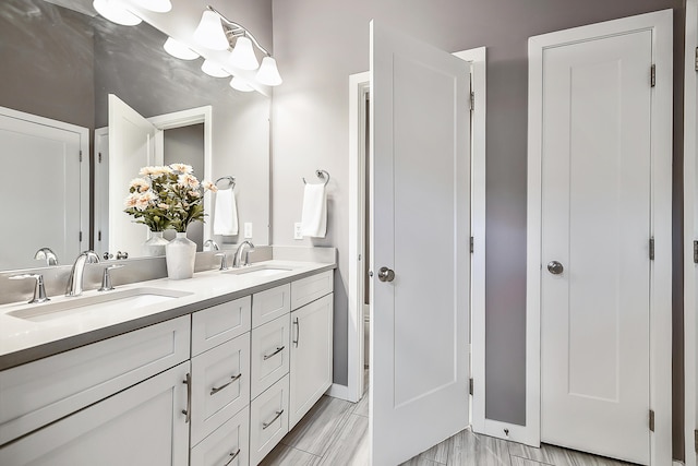 full bath featuring a sink and double vanity