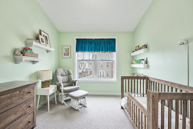 bedroom with carpet flooring, baseboards, and a crib