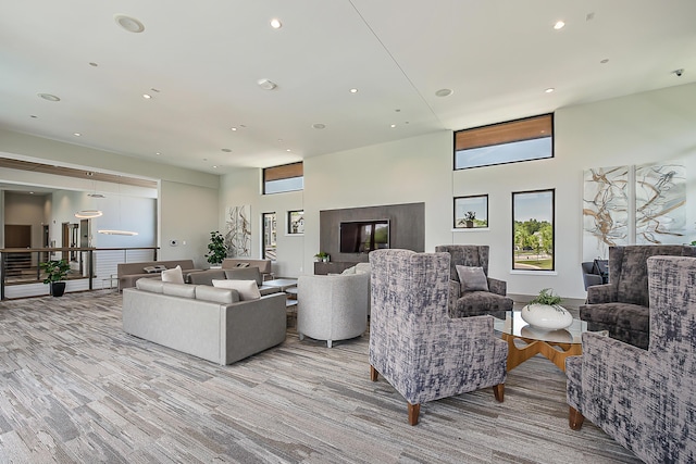 2825 Ridington Rd, Ann Arbor, MI 48105 - living room featuring a towering ceiling, recessed lighting, and light wood-type flooring
