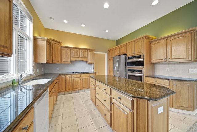 kitchen featuring a sink, light tile patterned floors, a center island, and stainless steel appliances