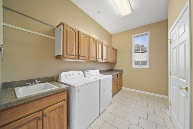 clothes washing area with light tile patterned floors, cabinet space, a sink, baseboards, and washing machine and dryer