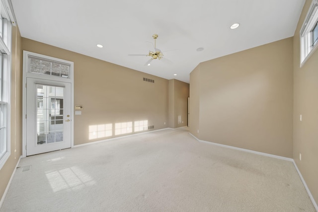 unfurnished living room featuring a ceiling fan, visible vents, recessed lighting, light carpet, and baseboards