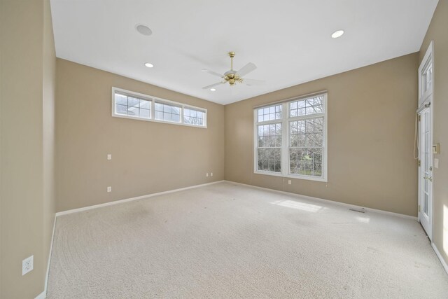 empty room with light colored carpet, baseboards, a ceiling fan, and recessed lighting