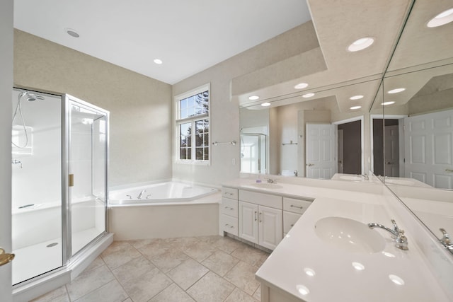 bathroom featuring a stall shower, a garden tub, a sink, and recessed lighting