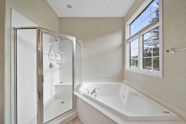full bathroom with a shower stall and a garden tub