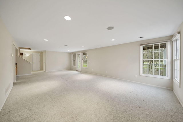 carpeted empty room with visible vents, baseboards, and recessed lighting