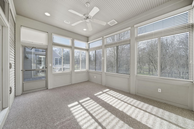 unfurnished sunroom featuring visible vents and a ceiling fan