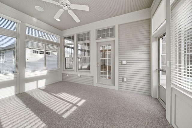 unfurnished sunroom featuring a ceiling fan