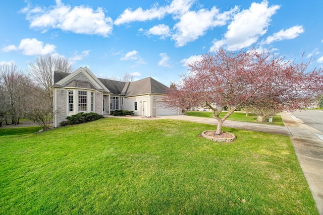 view of front facade featuring concrete driveway, a front yard, and an attached garage
