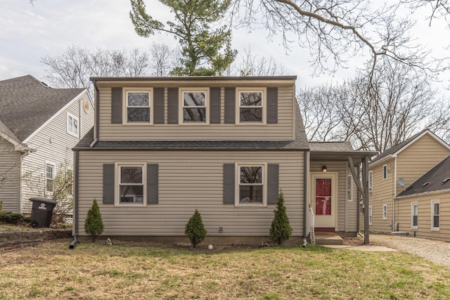 bungalow featuring a front yard, entry steps, and a shingled roof