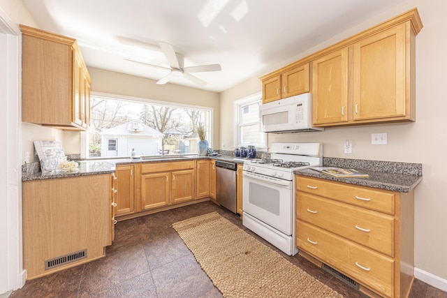 kitchen with visible vents, baseboards, a sink, ceiling fan, and white appliances
