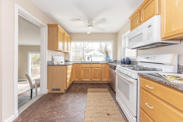 kitchen with white appliances, visible vents, a sink, and ceiling fan