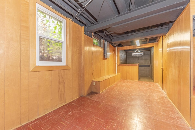 below grade area featuring wood walls and tile patterned floors
