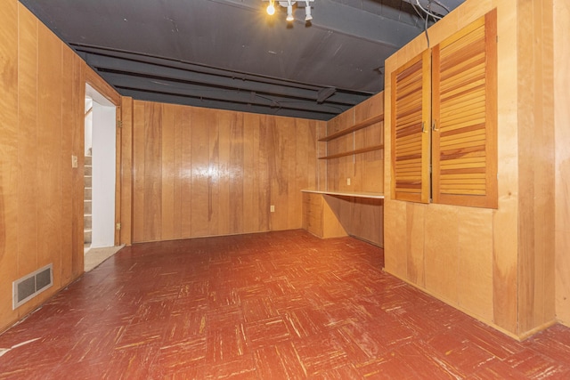 finished below grade area with visible vents and wood walls