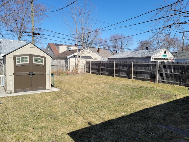 view of yard with an outdoor structure, fence private yard, and a shed