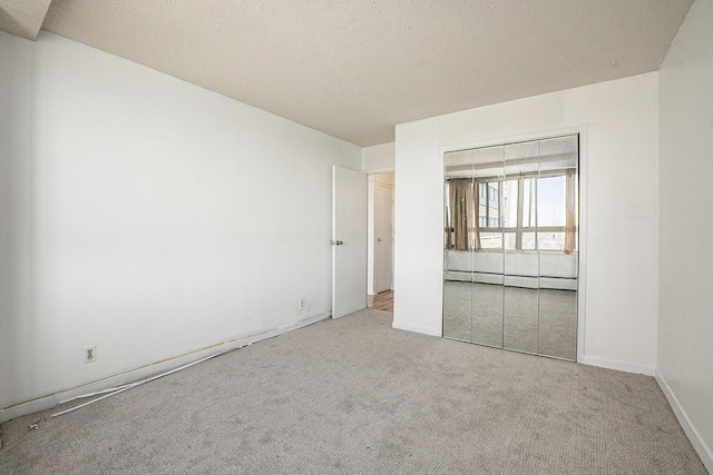 8900 E Jefferson Ave Unit 1109, Detroit, MI 48214 - unfurnished bedroom with baseboard heating, a closet, and carpet floors
