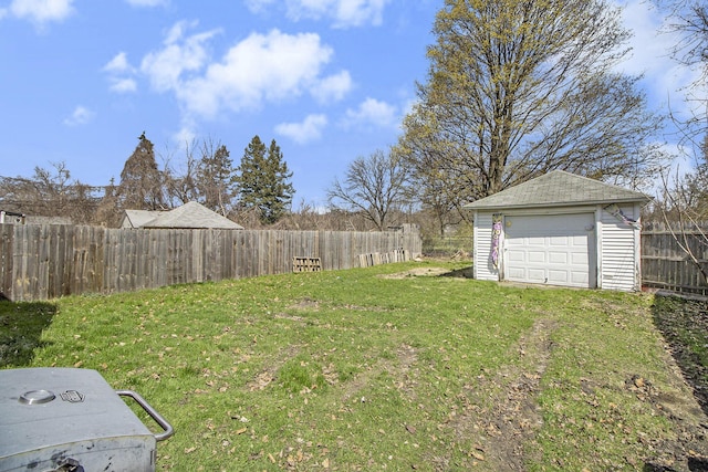 718 Harrison St, Kalamazoo, MI 49007 - view of yard featuring a garage, an outbuilding, and a fenced backyard