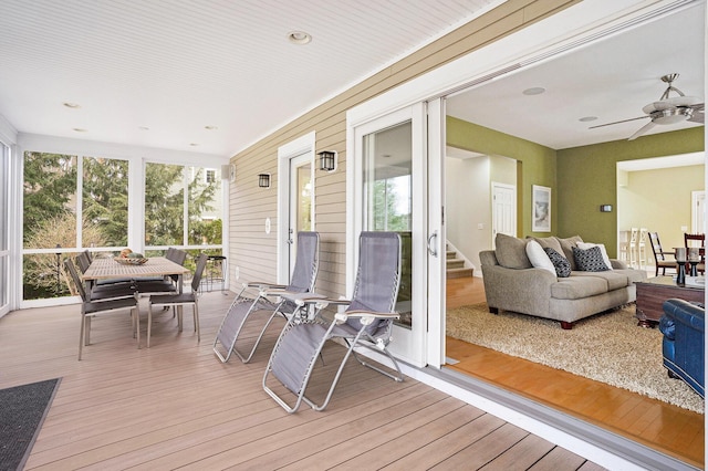 sunroom featuring a ceiling fan