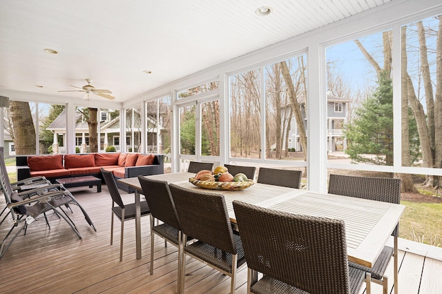 sunroom / solarium featuring ceiling fan, outdoor dining area, and an outdoor hangout area