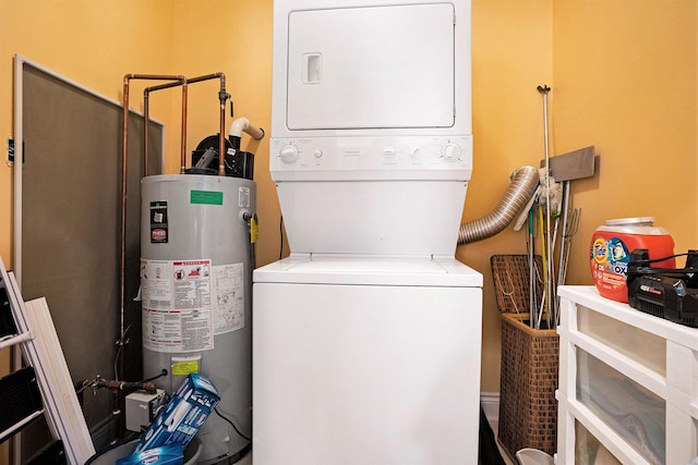 laundry room with laundry area, gas water heater, and stacked washer / drying machine