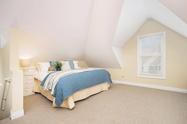 carpeted bedroom with baseboards and lofted ceiling