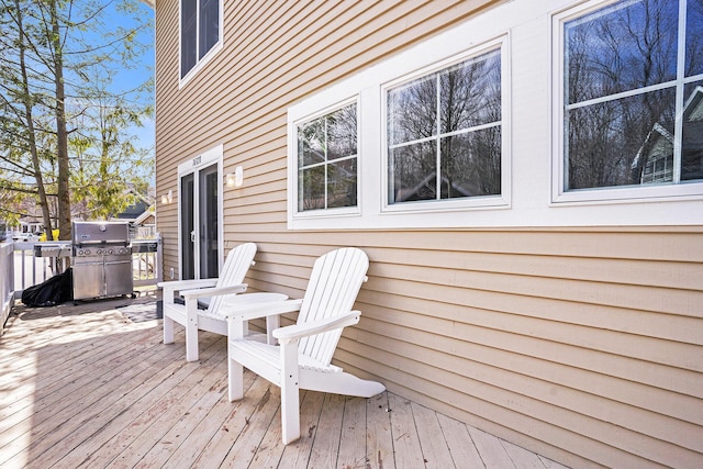wooden deck with a grill