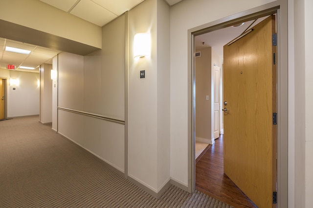 hall with carpet floors and baseboards