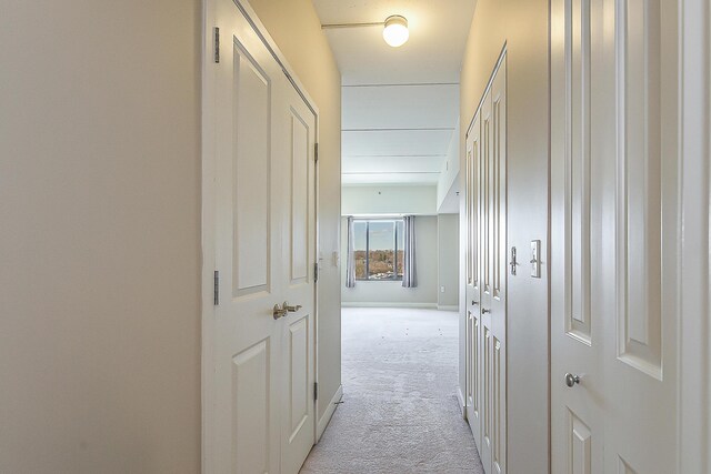 corridor featuring light carpet