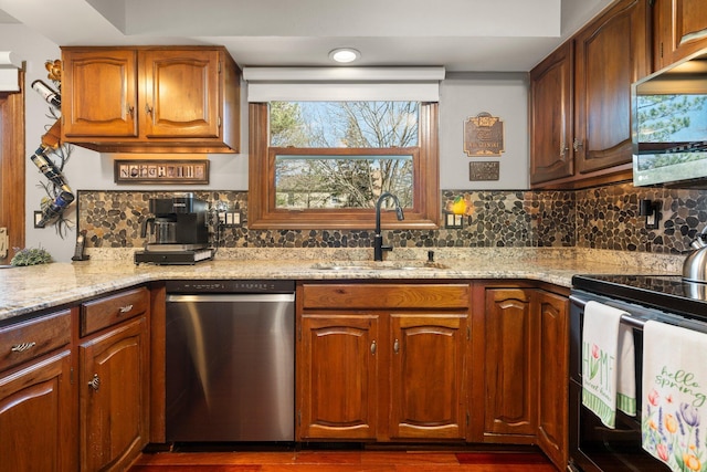 16264 White Haven Dr, Northville, MI 48168 - kitchen with a sink, decorative backsplash, appliances with stainless steel finishes, and light stone counters