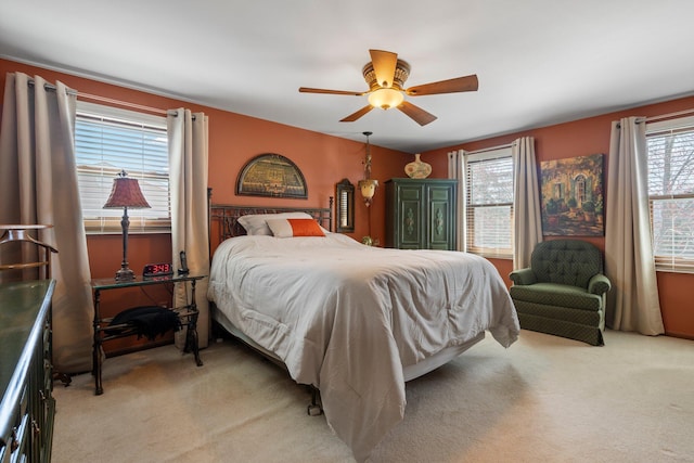 16264 White Haven Dr, Northville, MI 48168 - bedroom featuring light colored carpet, ceiling fan, and multiple windows
