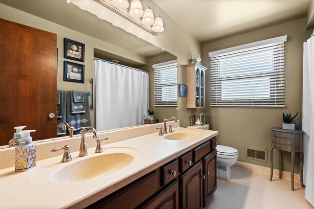 16264 White Haven Dr, Northville, MI 48168 - full bathroom with tile patterned floors, baseboards, a sink, and toilet